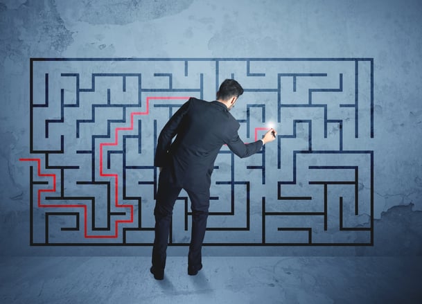 Businessman finding the solution of a maze